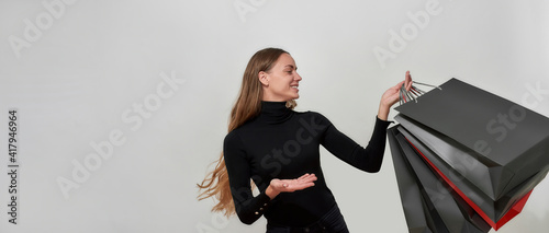 Obraz na płótnie Beautiful young caucasian woman with long hair wearing black clothes smiling, po