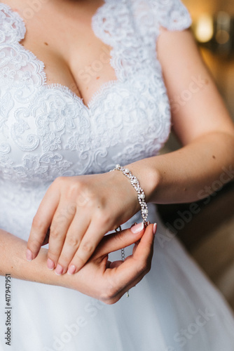 the bride wears a wedding bracelet on her left hand