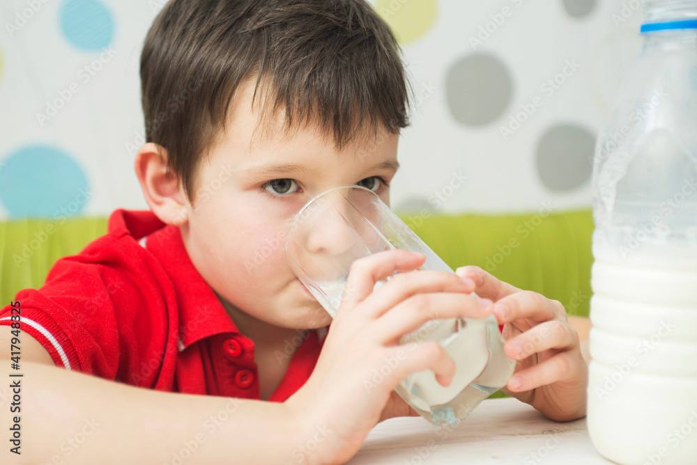 Cute little boy drinking a glass of milk. Healthy food Cute little boy drinking a glass of milk. Healthy food