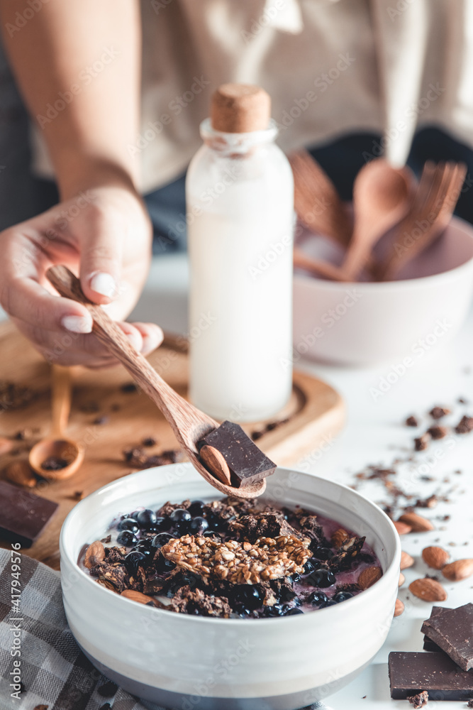 A young girl drinks morning coffee, eats a healthy breakfast and reads a book. Morning routine. Stylish manicure. Correct habits. Holding a cup in his hands A young girl drinks morning coffee, eats a healthy breakfast and reads a book. Morning routine. Stylish manicure. Correct habits. Holding a cup in his hands