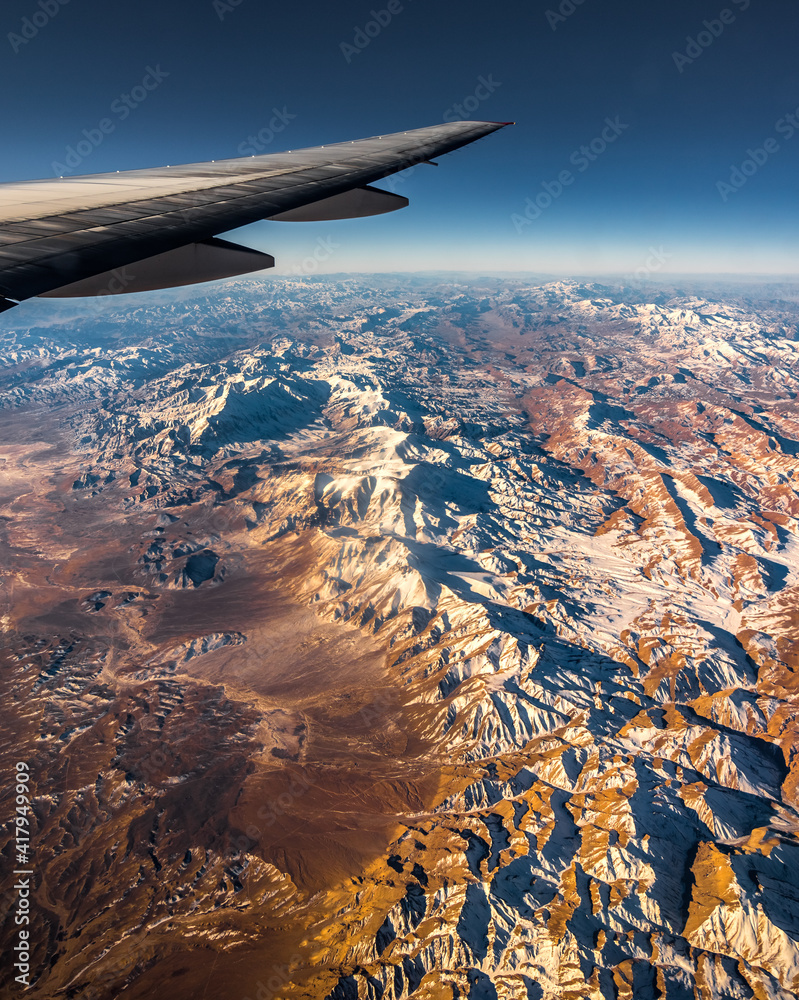 Aerial View from an Airplane. Flying above Beautiful Land at Sunrise.