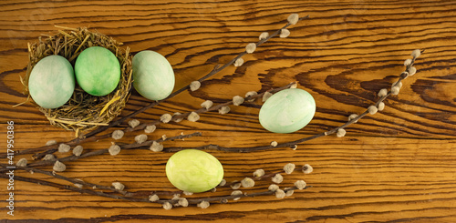 image of festive easter eggs and willow branches on a wooden table