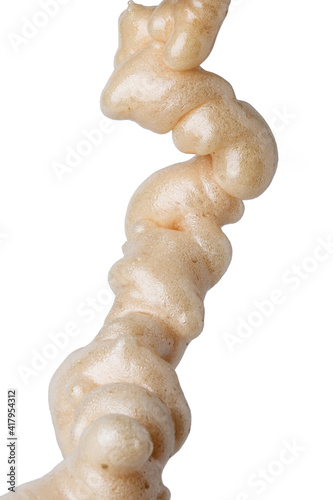 Fragment of solidified polyurethane foam isolated on white background