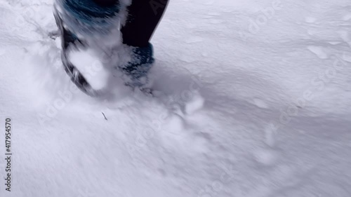Walking in the snow. Camera following footsteps of female walking in boots in the forest. Different angles. High quality audio of crunching snow and woodland ambience. ASMR style video.