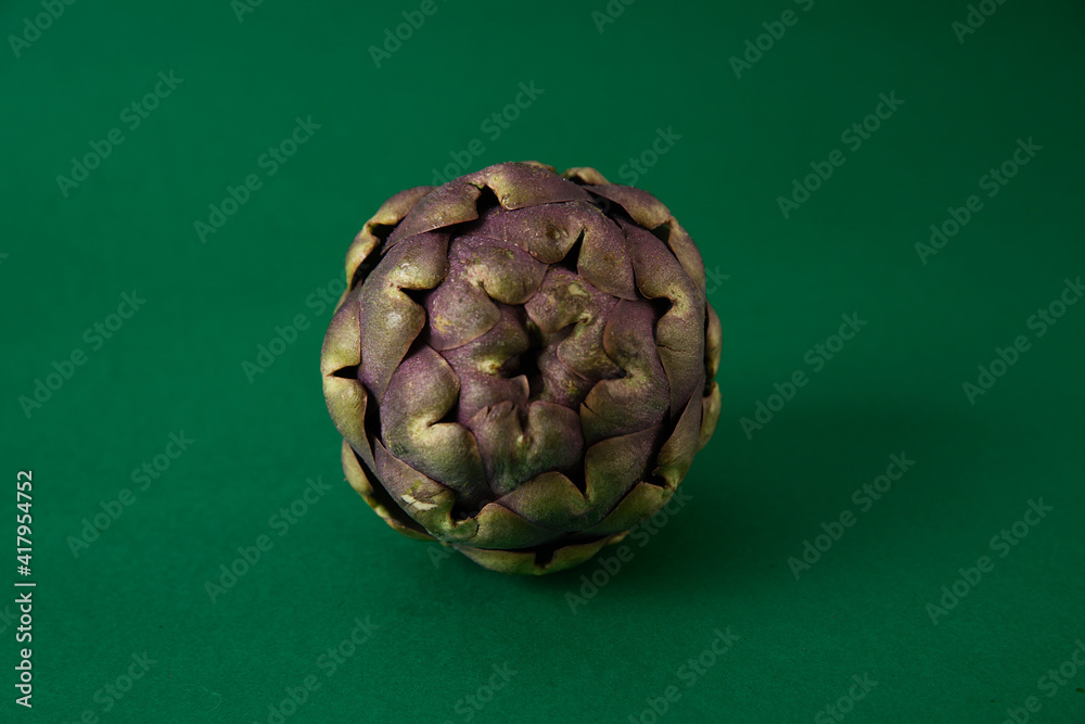 Fototapeta premium Fresh Artichoke on the dark green background