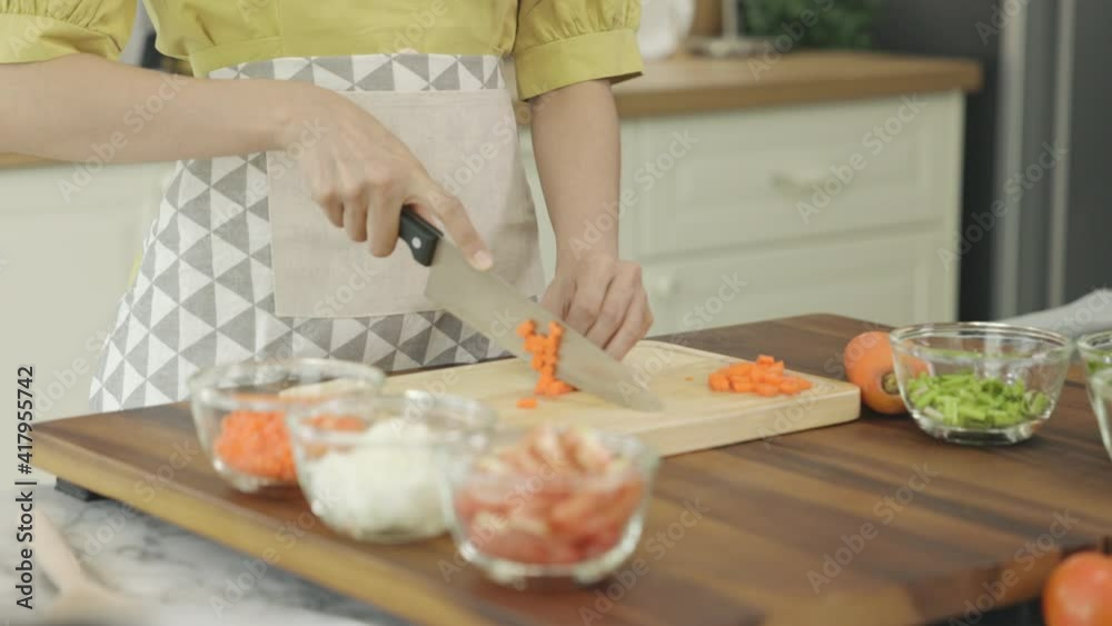 Close up hand of wife Prepare to cook for breakfast for her husband at home. Slice carrot Close up hand of wife Prepare to cook for breakfast for her husband at home. Slice carrot
