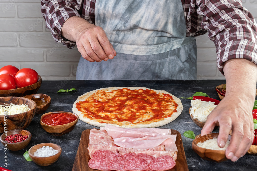 Pizza preparation with chef hands