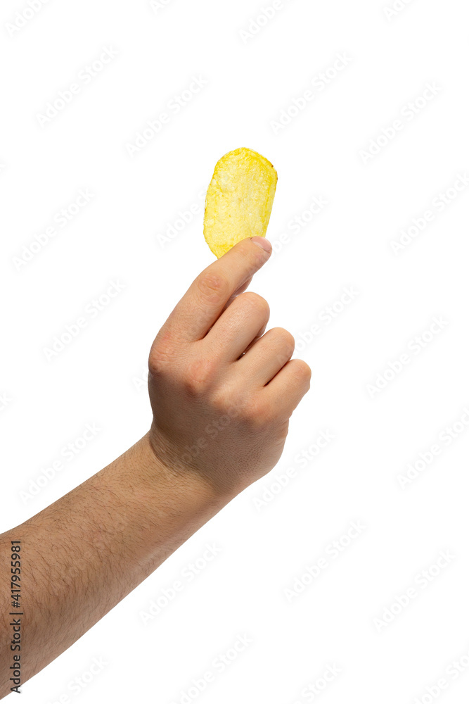 male hand holds potato chips. Chips - an appetizer that is thin slices of potatoes male hand holds potato chips. Chips - an appetizer that is thin slices of potatoes