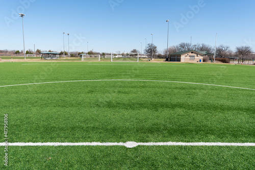 View of a soccer goal from the center circle at mid field