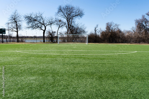 Soccer goal with trees and lake in the background