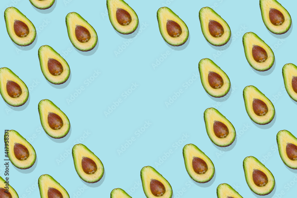 Avocado pattern on bright blue background with free space for text Avocado pattern on bright blue background with free space for text