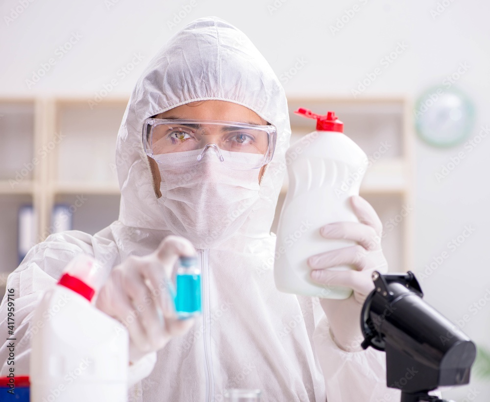 Chemist checking the quality of bathroom supplies Chemist checking the quality of bathroom supplies
