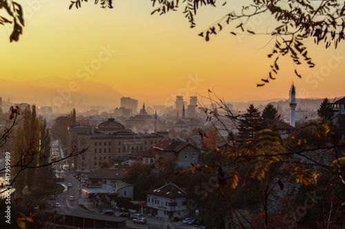 Beautiful view of the city of Sarajevo. View of the City Hall of Sarajevo and the silhouettes of other sights of the city of Sarajevo. Colorful sky at sunset.