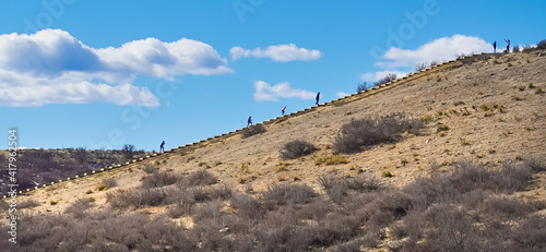 hikers in distance hiking an incline