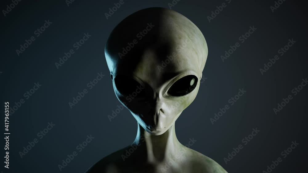 Spooky alien's face on black background. UFO and extraterrestrial life concept. Spooky alien's face on black background. UFO and extraterrestrial life concept.