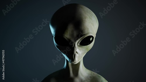 Spooky alien's face on black background. UFO and extraterrestrial life concept. photo