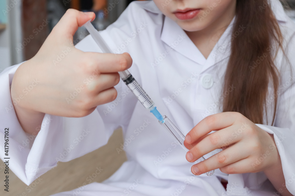 nurse with syringe.
A child in the uniform of a nurse holds a syringe with a flask in his hands, close-up side view. nurse with syringe.
A child in the uniform of a nurse holds a syringe with a flask in his hands, close-up side view.