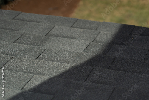 Gray roof shingles in sun and shade