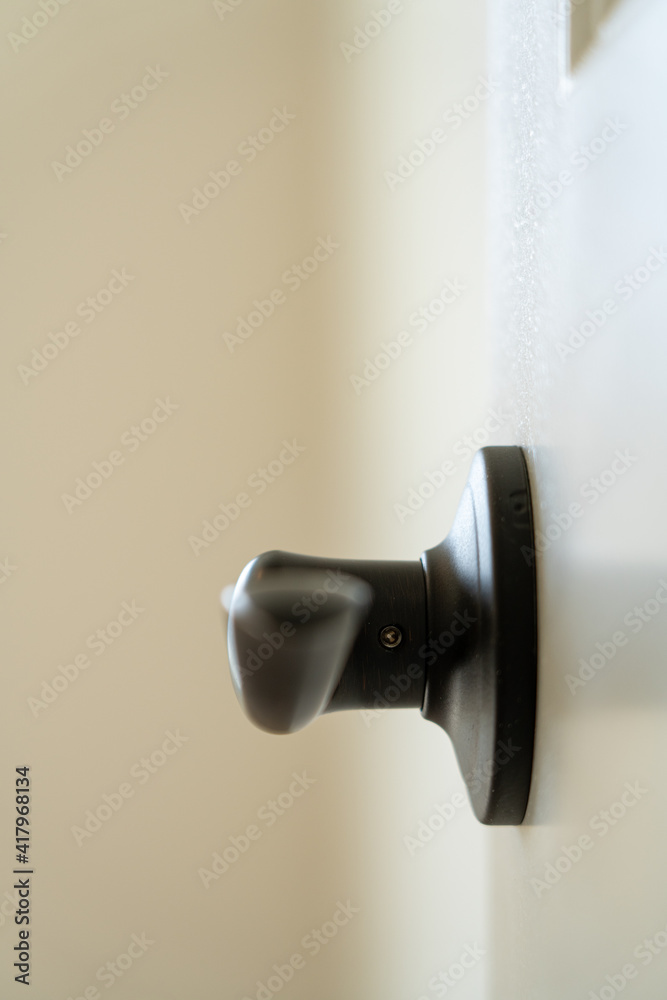 Closeup of metal door handle on a white doo Closeup of metal door handle on a white doo