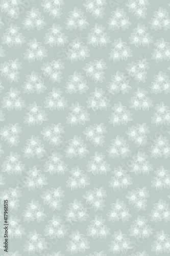 A beautiful and delicate pattern of white tiny flowers on a green pastel color. Seamless wallpaper for design, packaging paper, postcards, banners