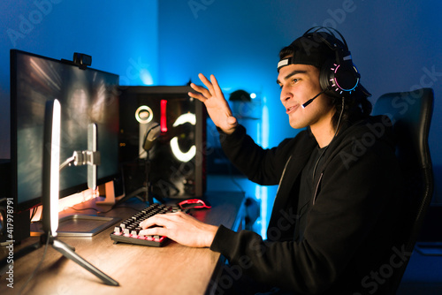 Latin man live streaming while gaming on his computer