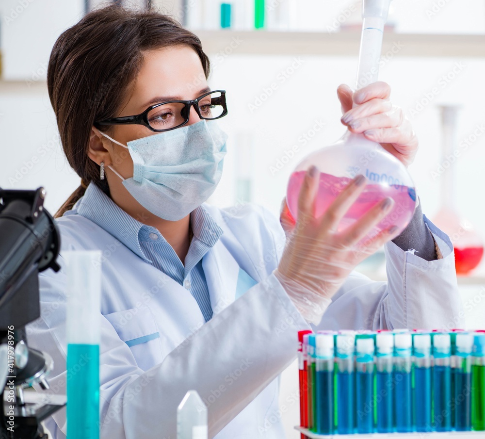 Female chemist working in hospital lab Female chemist working in hospital lab