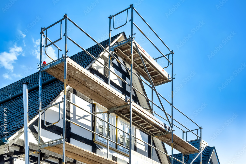Reconstruction and renovation of an old half-timbered house - obrazy, fototapety, plakaty 