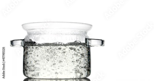 Cooking pot with boiling water on white background