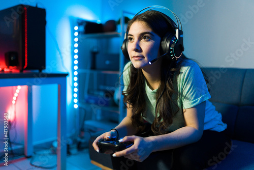 Woman using headphones and a microphone for a videogame photo