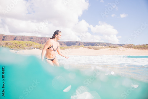 Girl surfing in Hawaii on longboard