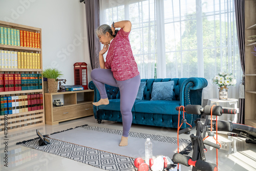 Senior woman exercise with standing oblique crunch at home