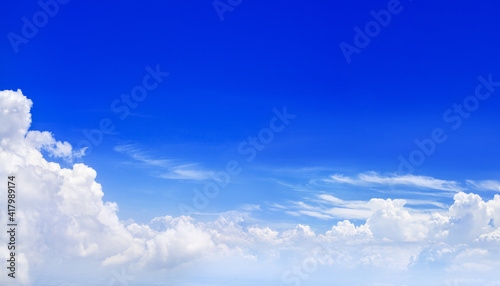 Clear blue sky above white cumulus clouds background panorama  beautiful aerial cloudscape panoramic view  skies backdrop fluffy cloud texture sunny cloudy heaven  airplane flight landscape copy space