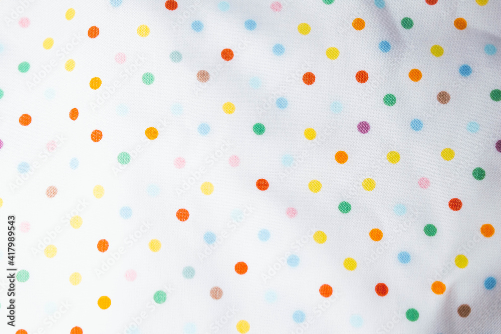 Fabric background with pattern. Rainbow balls on the fabric. Fabric background with pattern. Rainbow balls on the fabric.