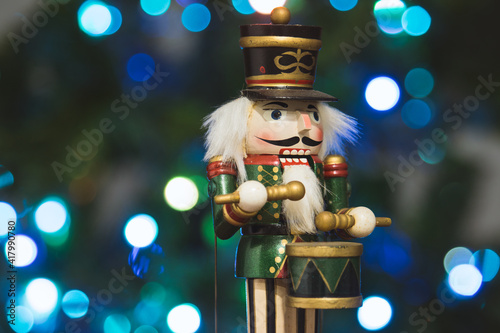 Festive nutcracker soldier with bokeh blurred fairy light