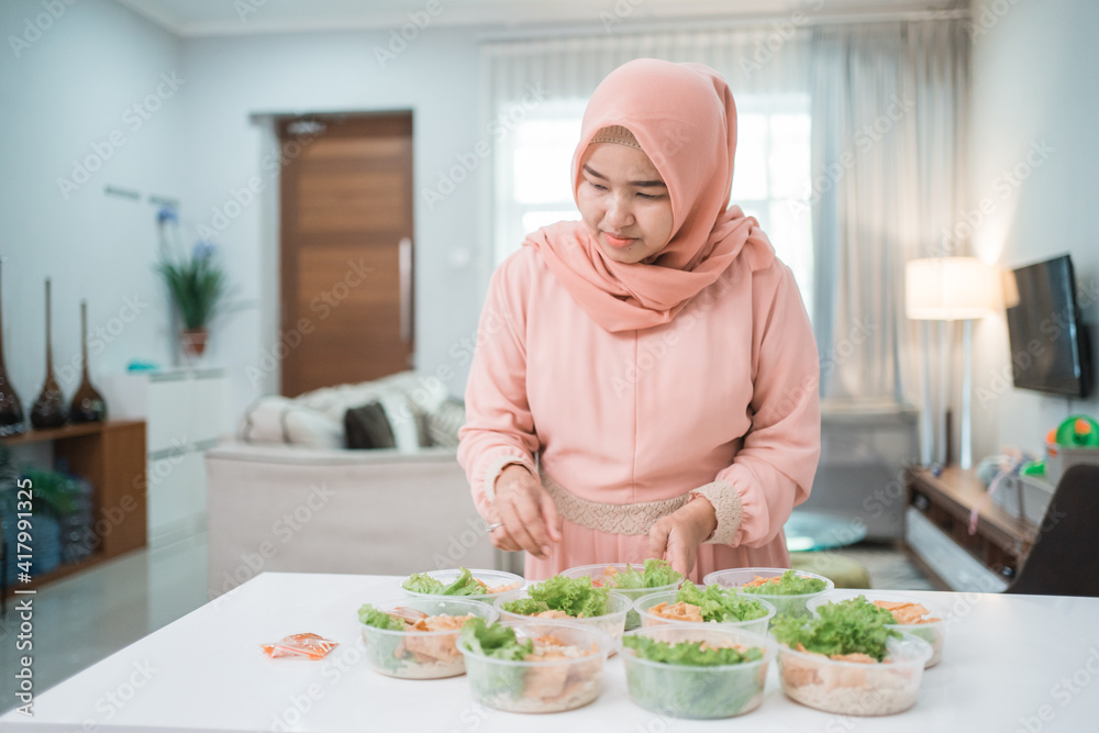 portrait of asian muslim woman food seller preparing her product at home kitchen portrait of asian muslim woman food seller preparing her product at home kitchen