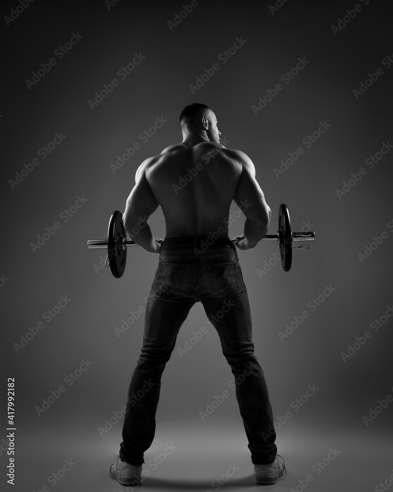 Muscular strong well built men bodybuilder weightlifter wearing jeans