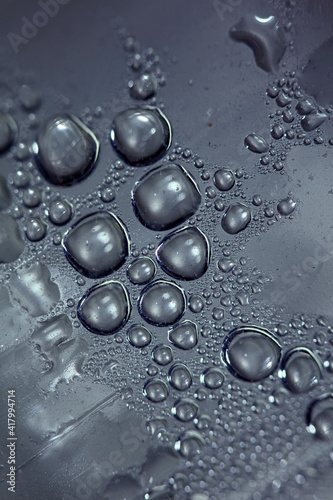 Macro shooting of water droplets beside the glass surface close up liquid drops modern background pattern high quality print