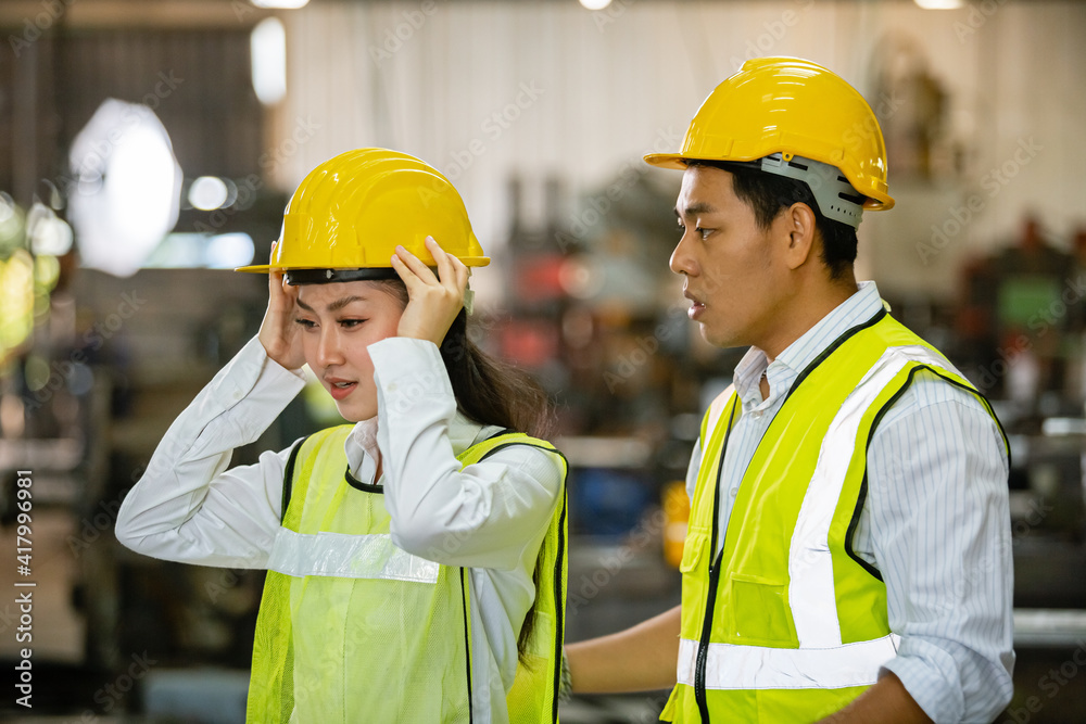 asian men and women engineer worker standing at factory talk about project, heavy industry factory concept. asian men and women engineer worker standing at factory talk about project, heavy industry factory concept.