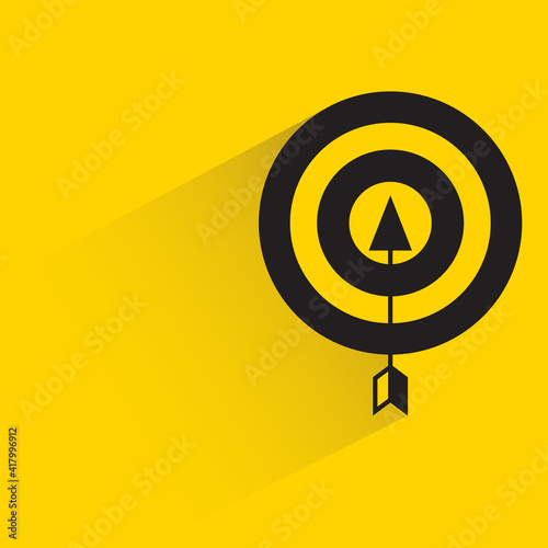 arrow and dart with shadow on yellow background
