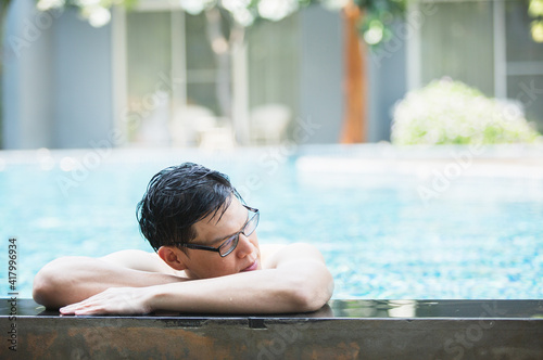 asian handsome man relax time at poolside  lifestyle travel in holiday vacation. relaxation concept.