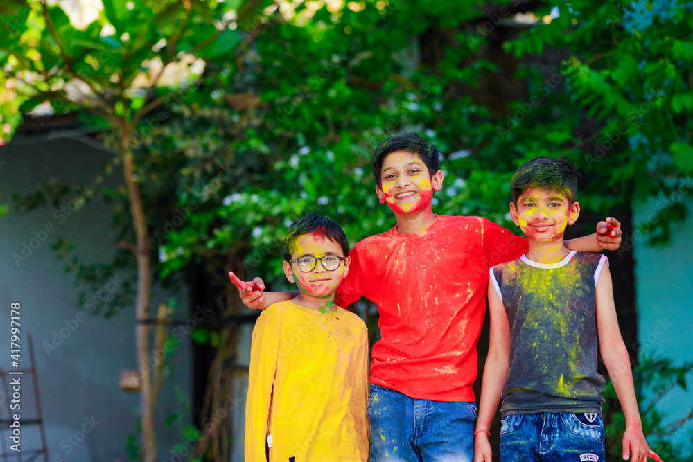 Cute indian little child’s group playing holi. Holi is colors festival in india