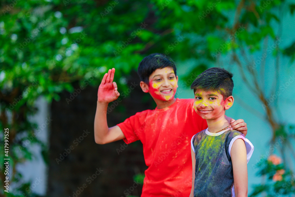 Cute indian little child’s group playing holi. Holi is colors festival in india Cute indian little child’s group playing holi. Holi is colors festival in india