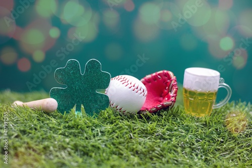 Baseball for St. Patrick's Day with Shamrock Clover on green grass photo