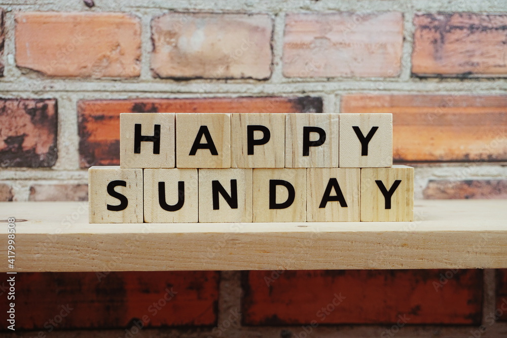 Obraz premium Happy Sunday alphabet letter on shelves wooden background