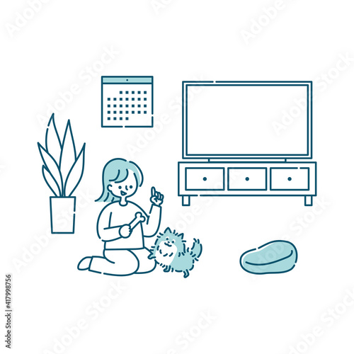 リビングで犬と一緒に遊ぶ女性