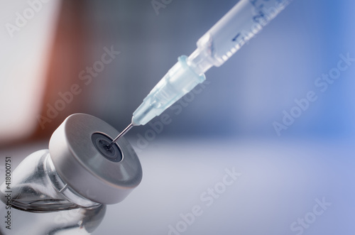 Syringe with liquid vaccines on table in laboratory,Concept covid-19 corona virus.