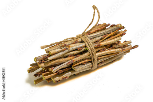 a bundle of twigs tied with a hemp rope on a white background