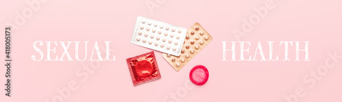 Contraceptive pills and condoms on color background. Concept of sexual health