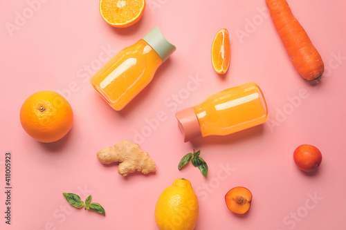 Healthy products and bottles of juice on color background