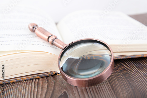 Open books and magnifying glass